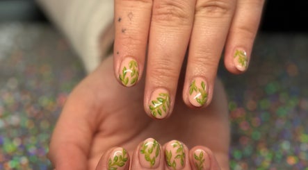 Green leaf nail art at SCULPTED BY LIZA in Bowling Green, Ohio, US, showcasing intricate design work.