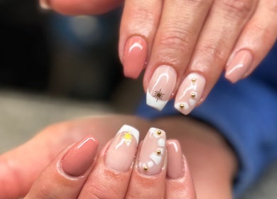 Stylish nail art at SCULPTED BY LIZA in Bowling Green, Ohio, US featuring nude color with gold accents.