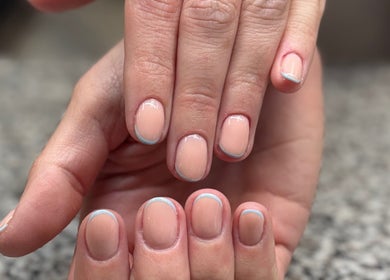 Freshly manicured nails featuring a subtle blue accent at SCULPTED BY LIZA, Bowling Green, Ohio, US.