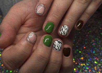 Stylish nail art with green, brown, and zebra designs at SCULPTED BY LIZA, Bowling Green, Ohio, US.