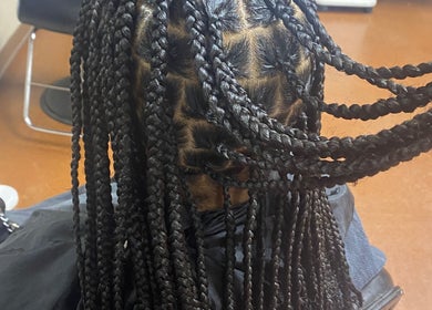 Intricate braided hairstyle at Done_byty, Katy, Texas, US, showcasing professional beauty services.
