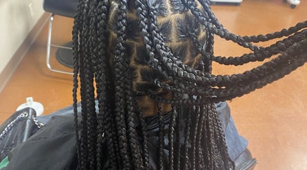 Intricate braided hairstyle at Done_byty, Katy, Texas, US, showcasing professional beauty services.