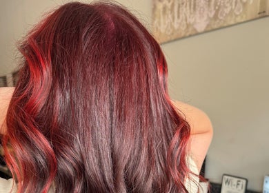 Vibrant crimson hair styling at Hair by Sah, East Massapequa, New York, US.