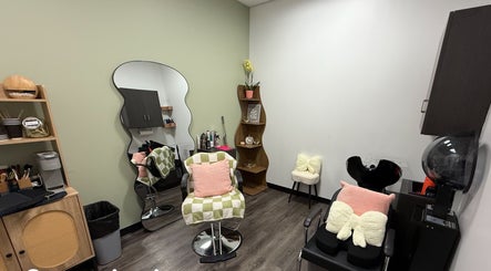Modern salon interior at Hair by Sah, East Massapequa, New York, US with stylish chairs and decor.