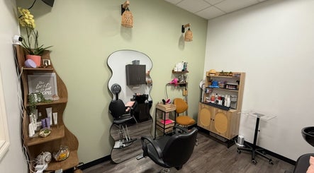 Modern styling chair and mirror at Hair by Sah, East Massapequa, New York, US. Shelving with products visible.