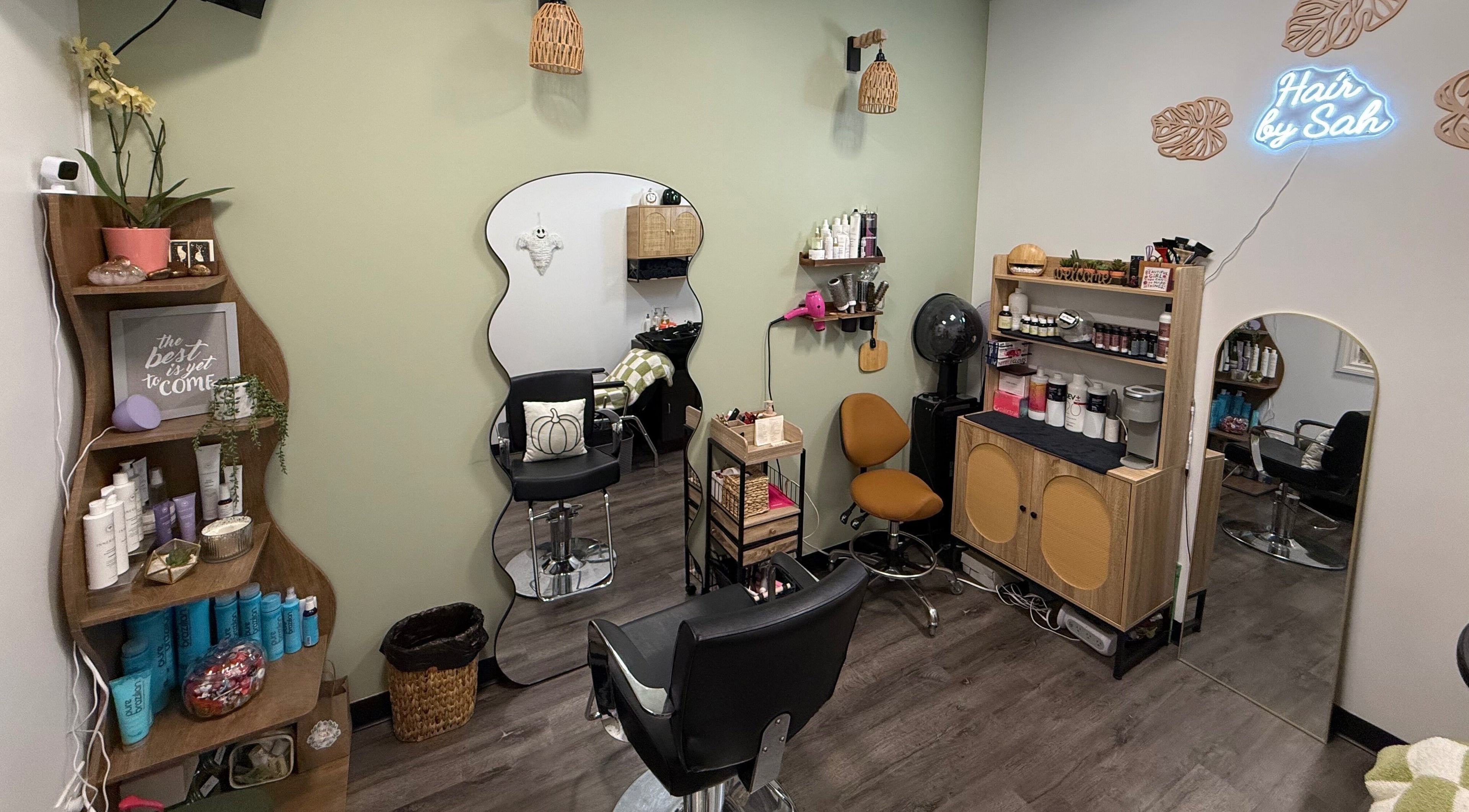 Chic interior of Hair by Sah salon in East Massapequa, New York, US showcasing stylish seating and decor.