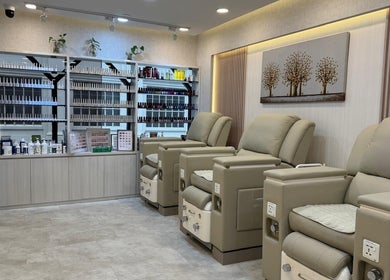 Luxurious seating area at HighBrow | The Adelphi, Singapore, Singapore, SG with reclining chairs and shelves.