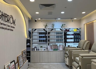 Luxurious interior of HighBrow | The Adelphi, Singapore, SG, featuring plush chairs and beauty products.