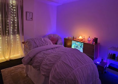 Cozy massage room at Lume, Melbourne, Victoria, AU with soft lighting and a serene ambiance.