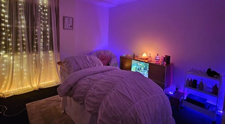 Cozy massage room at Lume, Melbourne, Victoria, AU with soft lighting and a serene ambiance.