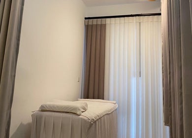 A tranquil treatment room with soft curtains at Sage Oasis Beauty Studio, Singapore, Singapore, SG.