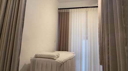 A tranquil treatment room with soft curtains at Sage Oasis Beauty Studio, Singapore, Singapore, SG.