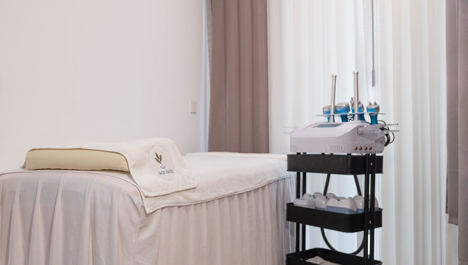Treatment room at Sage Oasis Beauty Studio, Singapore, Singapore, SG, featuring a comfortable spa bed and equipment.