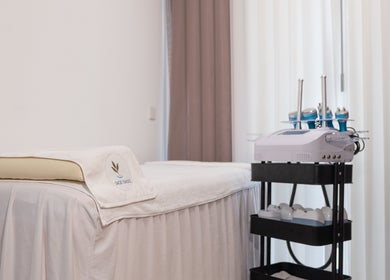 Treatment room at Sage Oasis Beauty Studio, Singapore, Singapore, SG, featuring a comfortable spa bed and equipment.