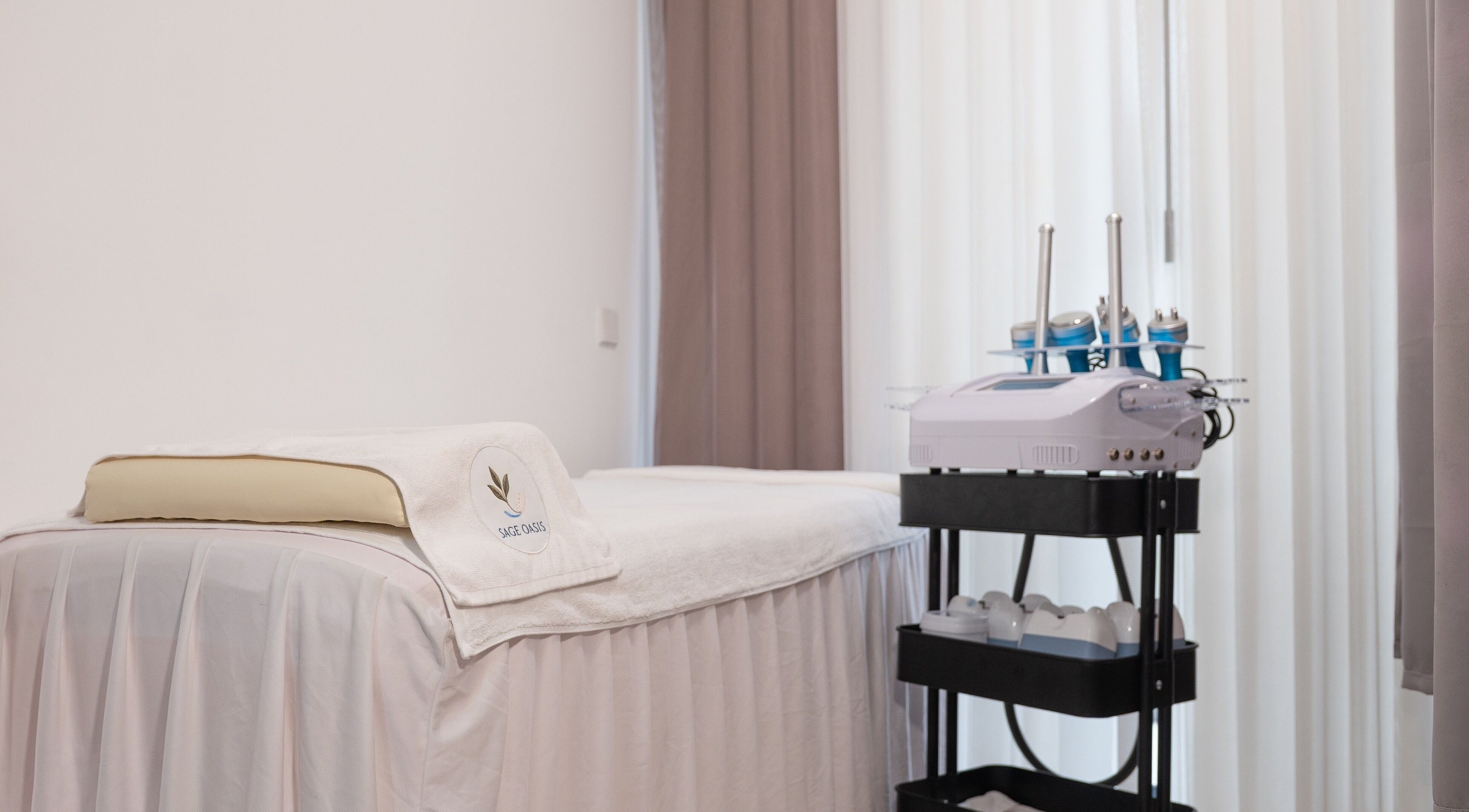 Treatment room at Sage Oasis Beauty Studio, Singapore, SG, with a serene setup and advanced equipment.