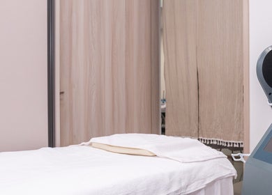 Treatment room at Sage Oasis Beauty Studio in Singapore with modern equipment and comfortable bedding.