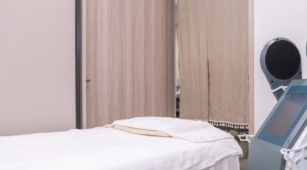 Treatment room at Sage Oasis Beauty Studio in Singapore with modern equipment and comfortable bedding.