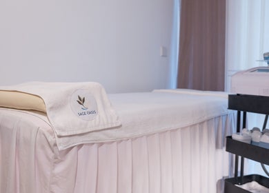 Cozy treatment room at Sage Oasis Beauty Studio, Singapore, SG, featuring a plush massage bed and soothing decor.