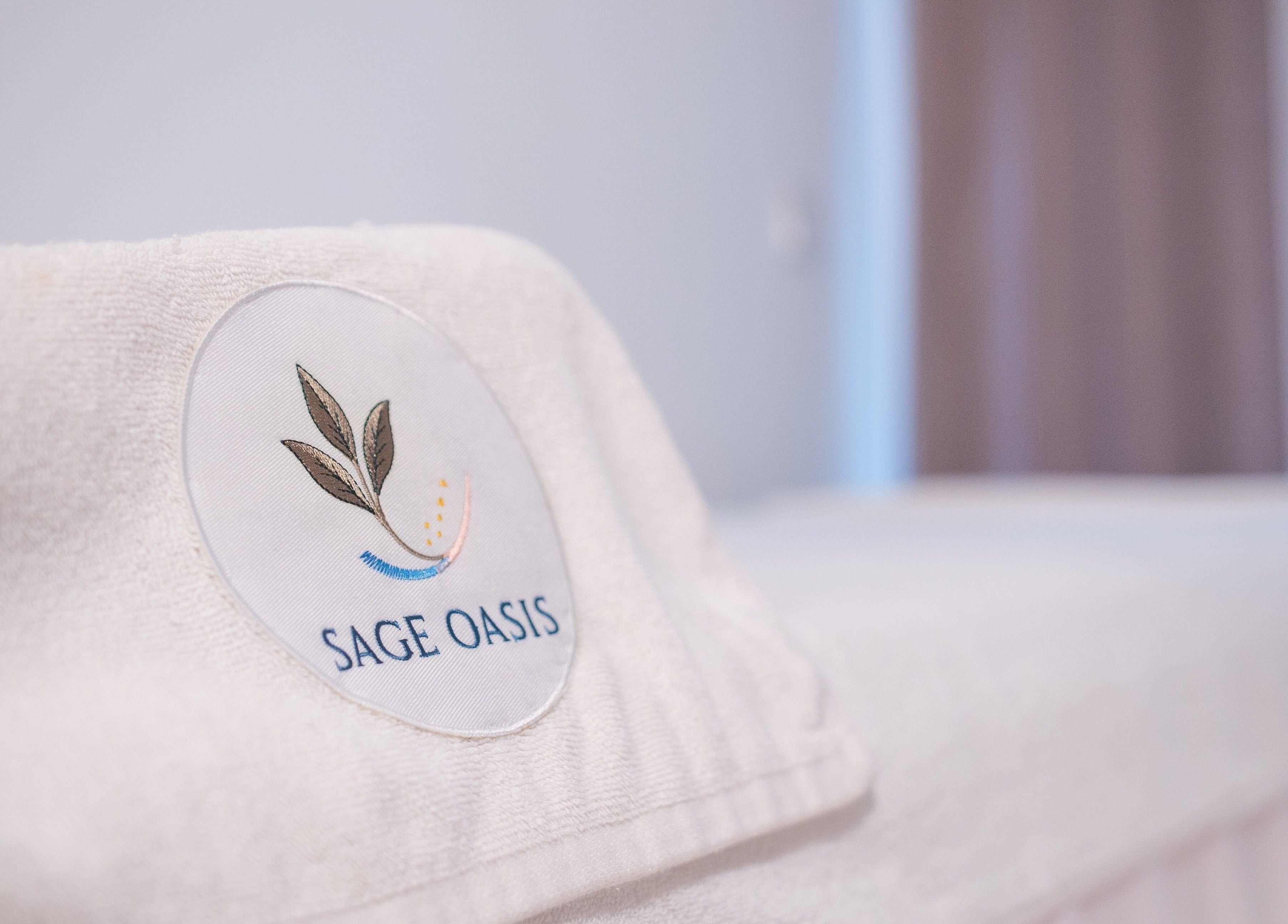 Close-up of a branded towel at Sage Oasis Beauty Studio in Singapore, SG, symbolizing luxury and relaxation.