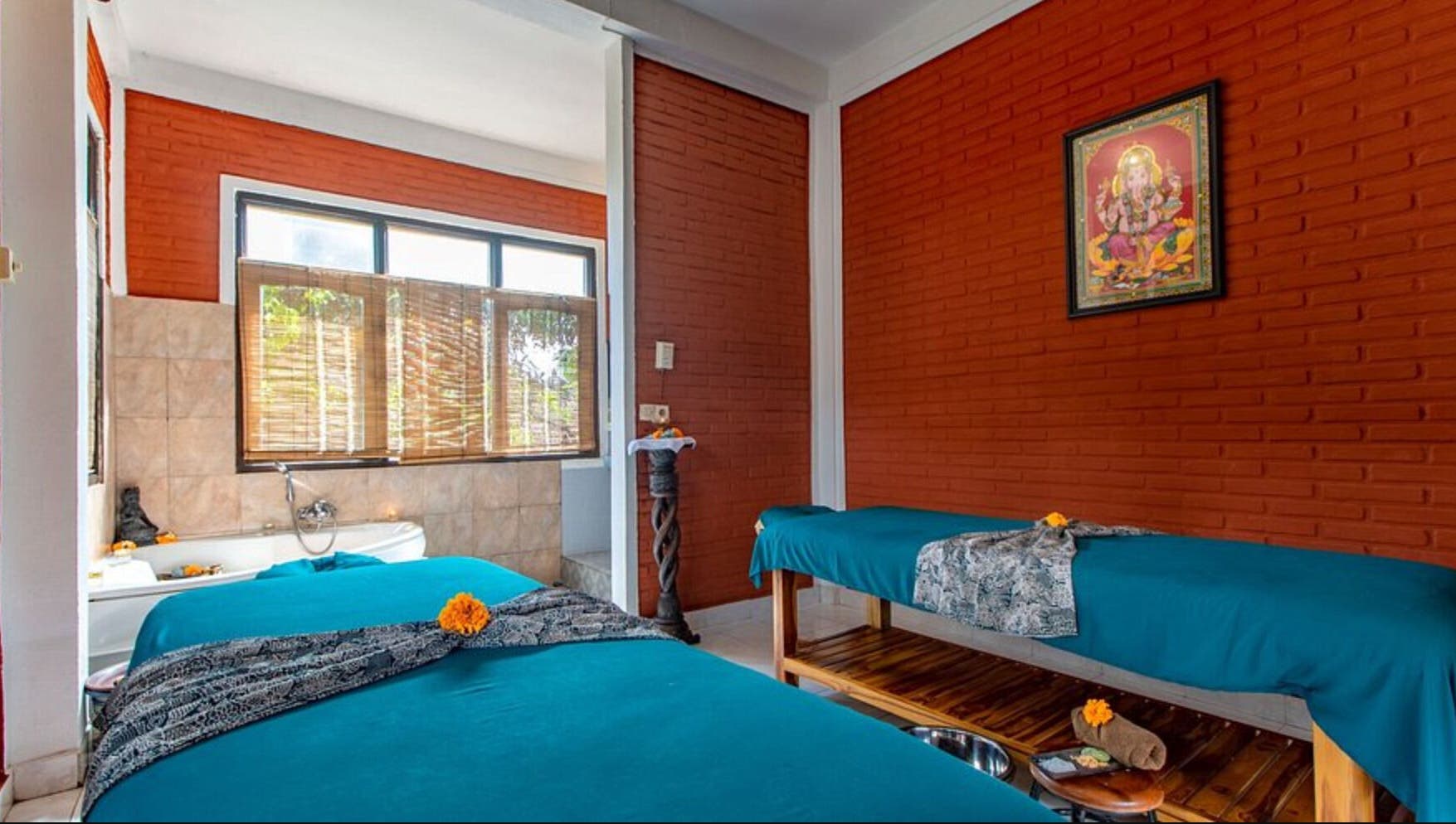 Relaxing therapy room at Ubud Bodyworks Centre in Bali, ID, featuring massage beds and tranquil decor.