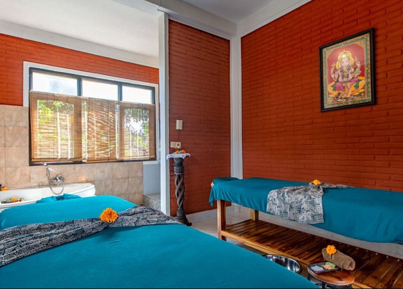 Relaxing therapy room at Ubud Bodyworks Centre in Bali, ID, featuring massage beds and tranquil decor.