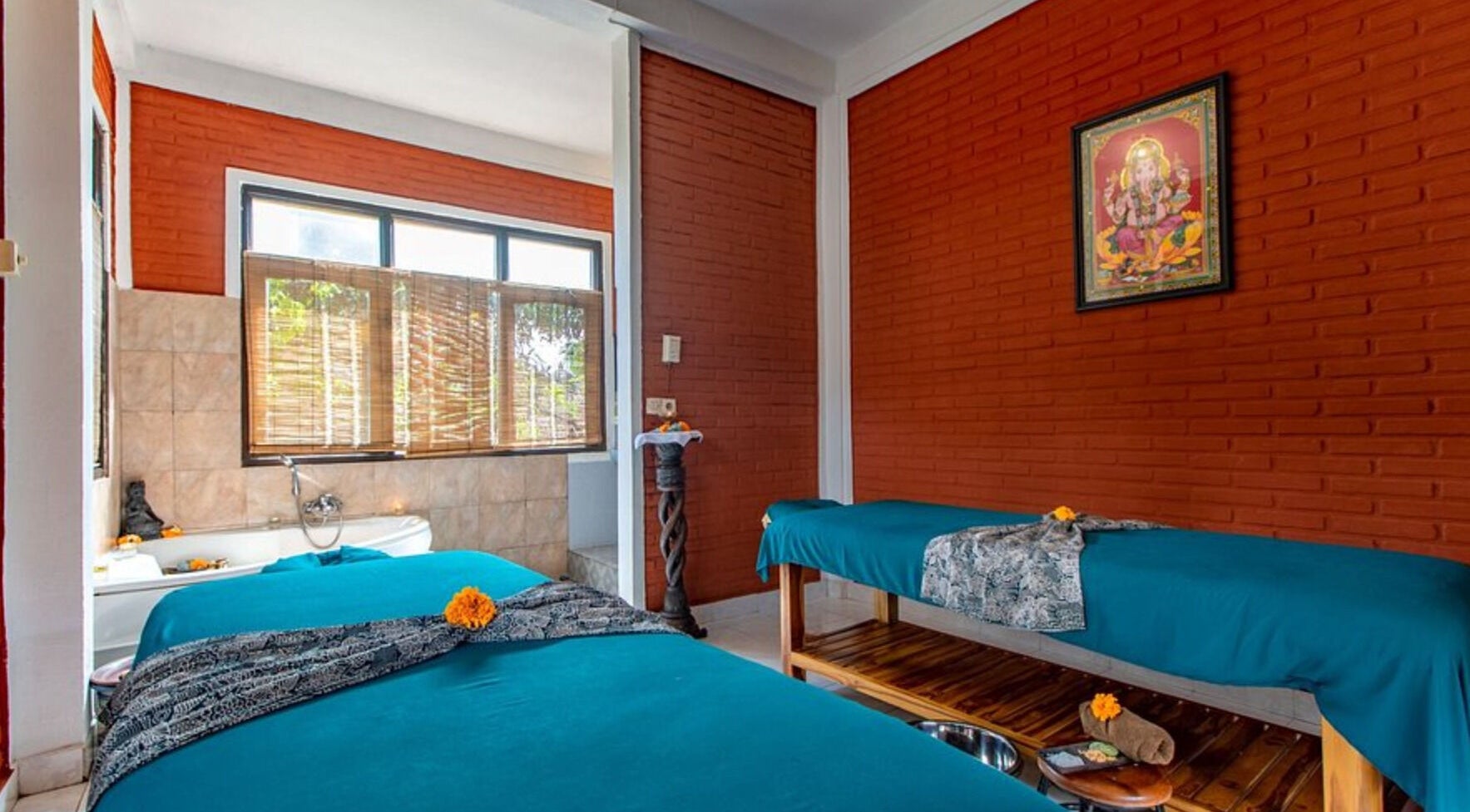 Relaxing therapy room at Ubud Bodyworks Centre in Bali, ID, featuring massage beds and tranquil decor.