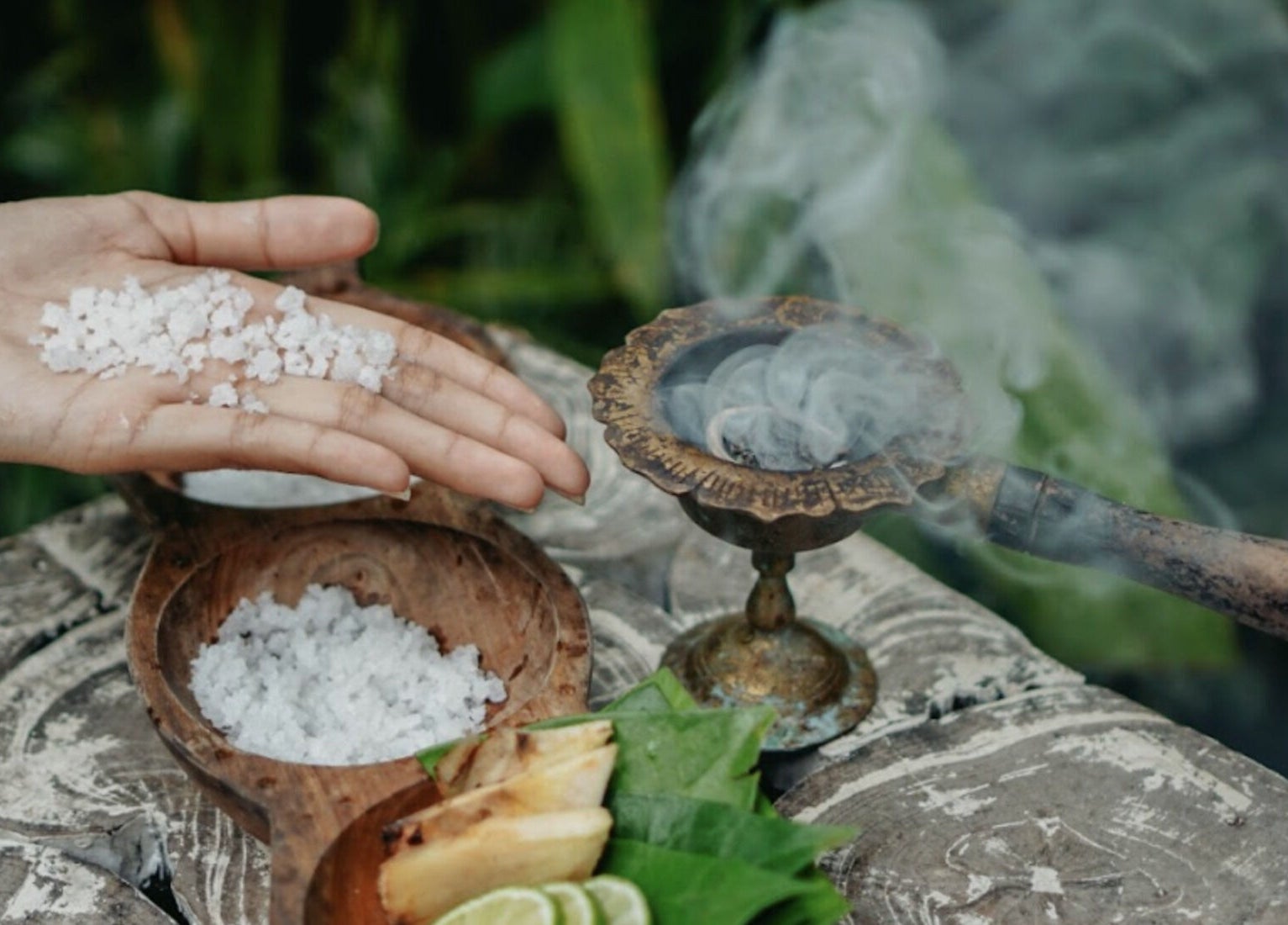 Hand holding sea salt beside incense at Om Ham Retreat & Resort, Bali, Bali, ID.