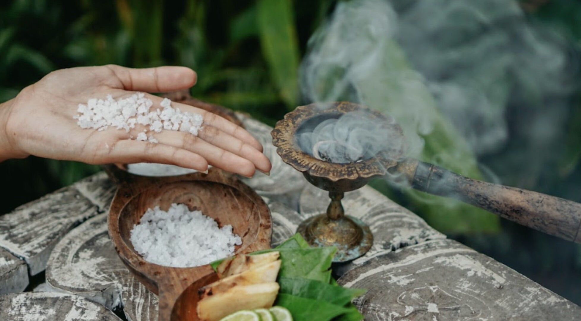 Hand holding sea salt beside incense at Om Ham Retreat & Resort, Bali, Bali, ID.