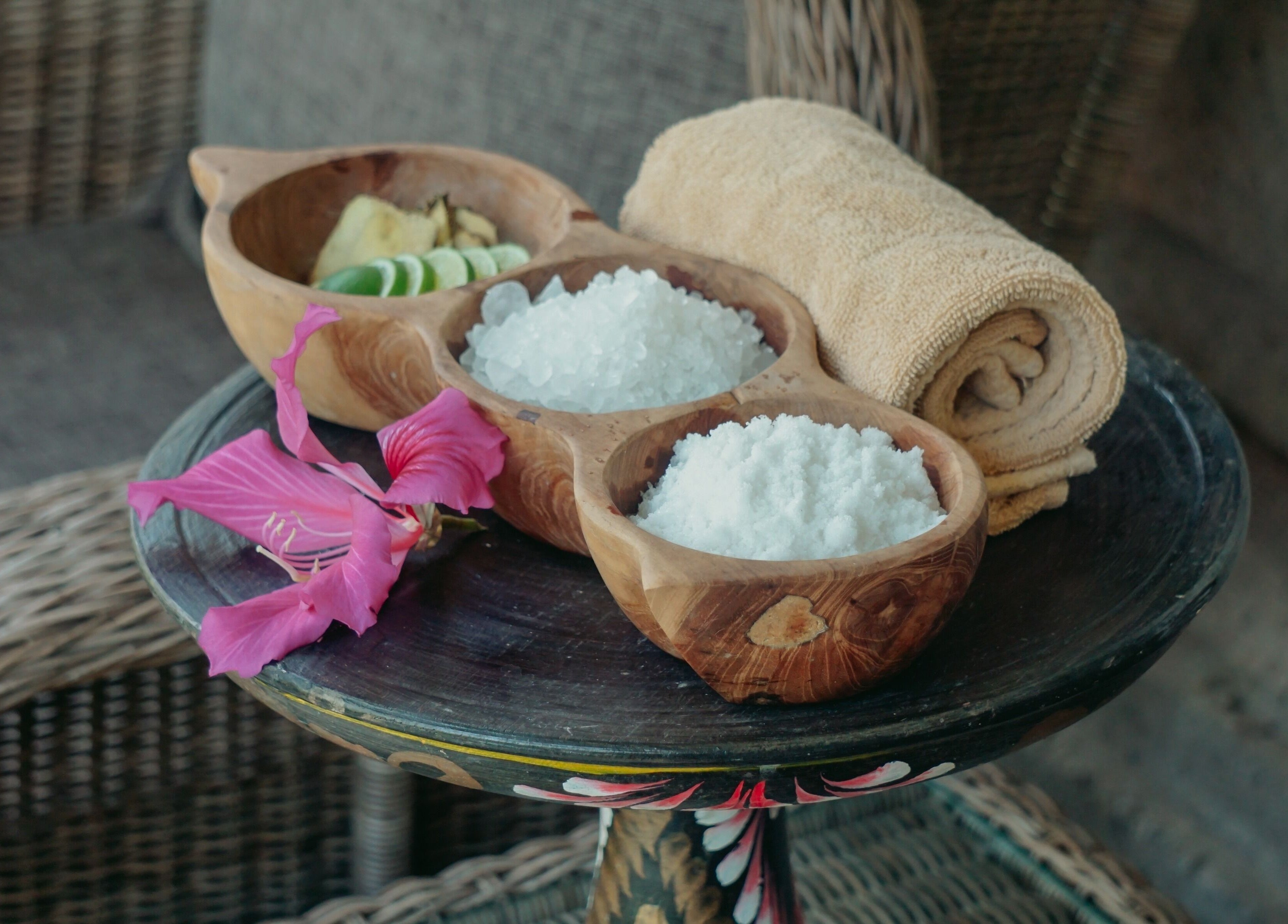 Spa essentials at Om Ham Retreat & Resort in Bali, Bali, ID featuring salt, lime, and towel in wooden bowls.