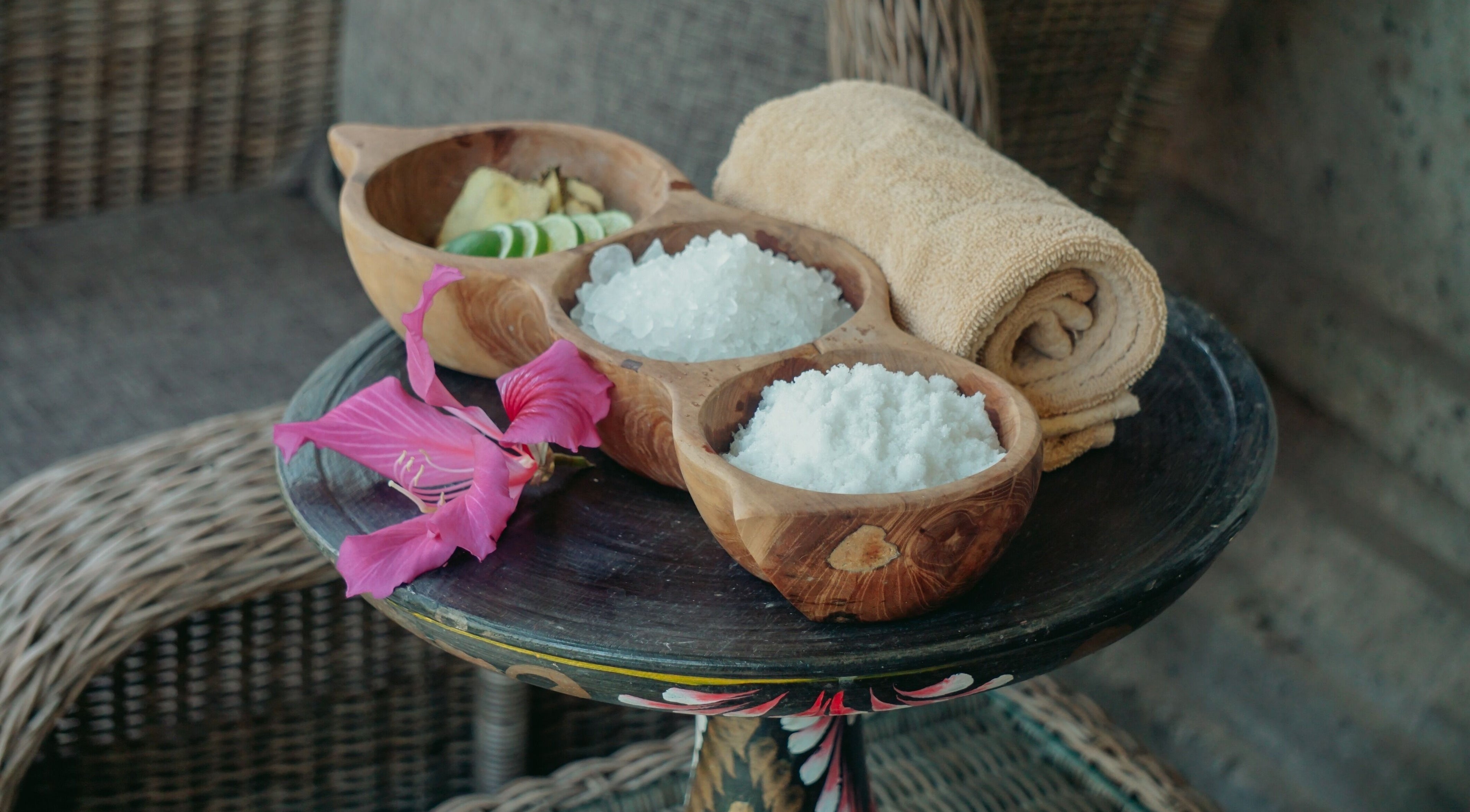 Spa essentials at Om Ham Retreat & Resort in Bali, Bali, ID featuring salt, lime, and towel in wooden bowls.