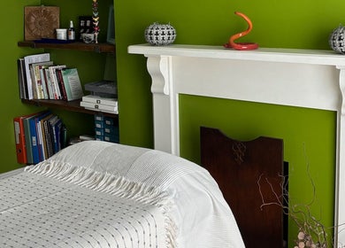 Cozy treatment room at Better Health Kinesiology, Cardiff, Wales, GB with warm decor and arranged books.