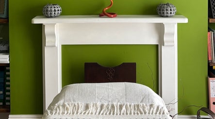 Cozy treatment room at Better Health Kinesiology, Cardiff, Wales, GB, featuring elegant decor with earthy tones.