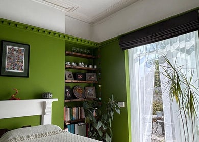 Bright, calming room at Better Health Kinesiology in Cardiff, Wales, GB with green walls and large window.