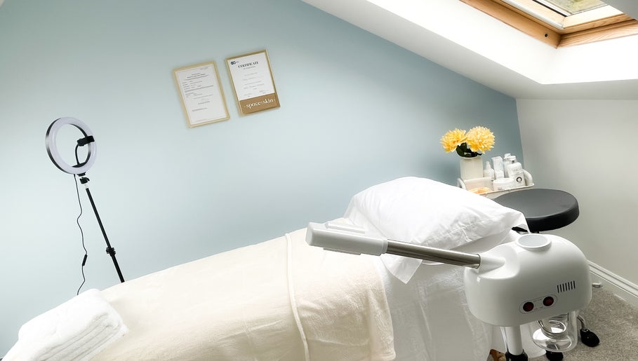 Relaxing treatment room at Soleil Skin Studio, Port Tennant, Wales, GB with calming decor and fresh flowers.
