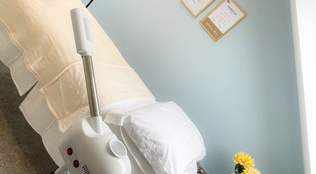 Relaxing treatment room at Soleil Skin Studio, Port Tennant, Wales, GB featuring a cozy bed and elegant decor.