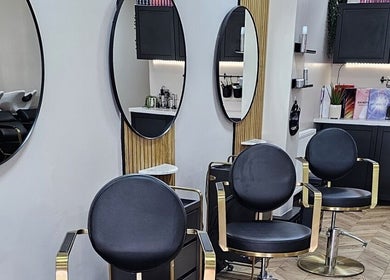 Elegant salon interior at Bianca Simone Hair & Beauty in Prestatyn, Wales, GB with stylish chairs and mirrors.