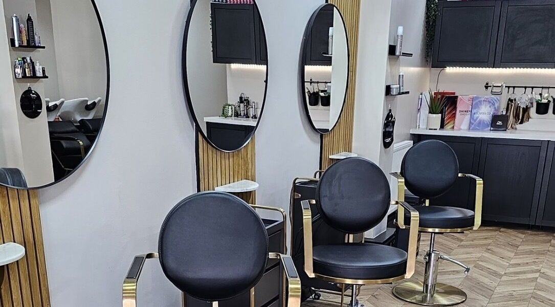 Elegant salon interior at Bianca Simone Hair & Beauty in Prestatyn, Wales, GB with stylish chairs and mirrors.