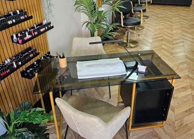 Manicure station at Bianca Simone Hair & Beauty in Prestatyn, Wales, GB showcasing nail polish selection and seating.