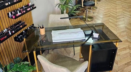 Manicure station at Bianca Simone Hair & Beauty in Prestatyn, Wales, GB showcasing nail polish selection and seating.