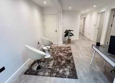 Modern lobby at Sasima Thai Massage Windsor, England, GB with sleek chairs and decor.