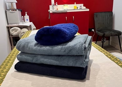 Cozy stacked towels at Sasima Thai Massage Windsor in Windsor, England, GB, offering a serene massage experience.