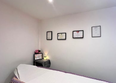 Cozy massage room at Sasima Thai Massage Windsor with certificates on wall, located in Windsor, England, GB.