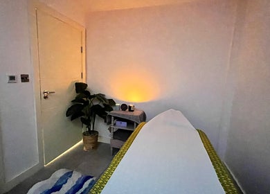 Relaxing massage room at Sasima Thai Massage Windsor, Windsor, England, GB, featuring ambient lighting and decor.