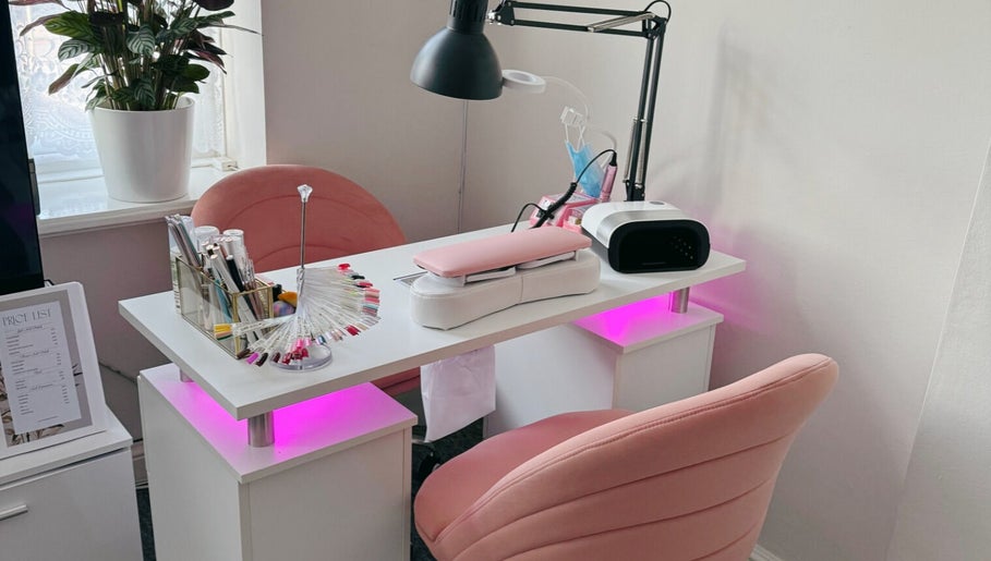Lumi Nails in London, England, GB features modern nail station with pink chairs and stylish decoration.
