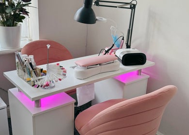 Lumi Nails in London, England, GB features modern nail station with pink chairs and stylish decoration.