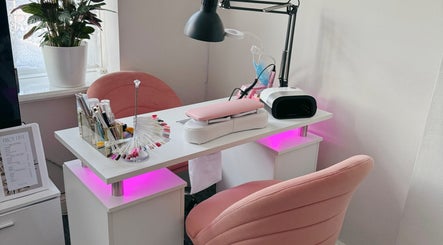 Lumi Nails in London, England, GB features modern nail station with pink chairs and stylish decoration.