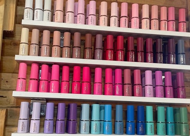 Vibrant nail polish collection at Monate Nails, Soweto, Gauteng, ZA, showcasing diverse color options.