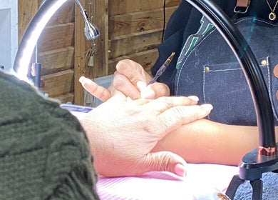 A technician expertly manicures a client's nails at Monate Nails in Soweto, Gauteng, ZA.