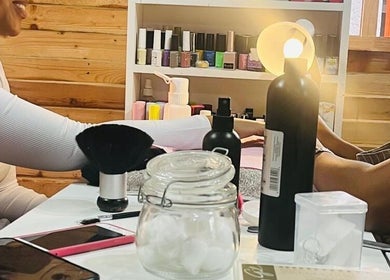 Guests enjoying nail treatment at Monate Nails, Soweto, Gauteng, ZA with various manicure tools visible.