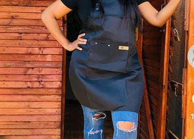 Stylish apron worn at Monate Nails, Soweto, Gauteng, ZA, showcasing modern salon fashion.